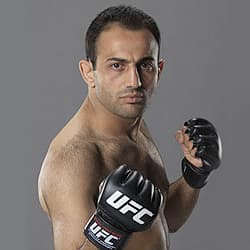 Roman Mitichyan in UFC gloves in a fighting stance against a grey backdrop
